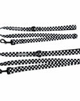Adjustable dog leashes in messy black and white checkered with black clasps and reflective Wag Trendz® labels