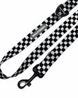 Adjustable dog leash with swivel clasp, buckle, and black and white checkered strap