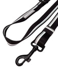 Black and white adjustable dog leash with reflective tag on a white background