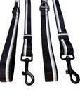 Two black dog leashes with gray and white stripes on a white background
