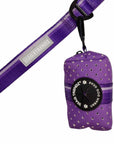NeoCool™ Sport Poop Bag Holder in purple logo dispenser hanging on purple dog leash with white background