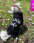Hooded Sweatshirt For Dogs - Shih Tzu mix wearing "Good Life" hooded sweatshirt in black - back view - Good Life on the back - sitting outdoors in a grassy field - Wag Trendz