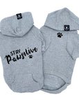 Hooded Sweatshirt For Dogs - "Stay Pawsitive" hooded sweatshirt in gray set - back view Stay Pawsitive with paw print front view with paw print - against solid white background - Wag Trendz