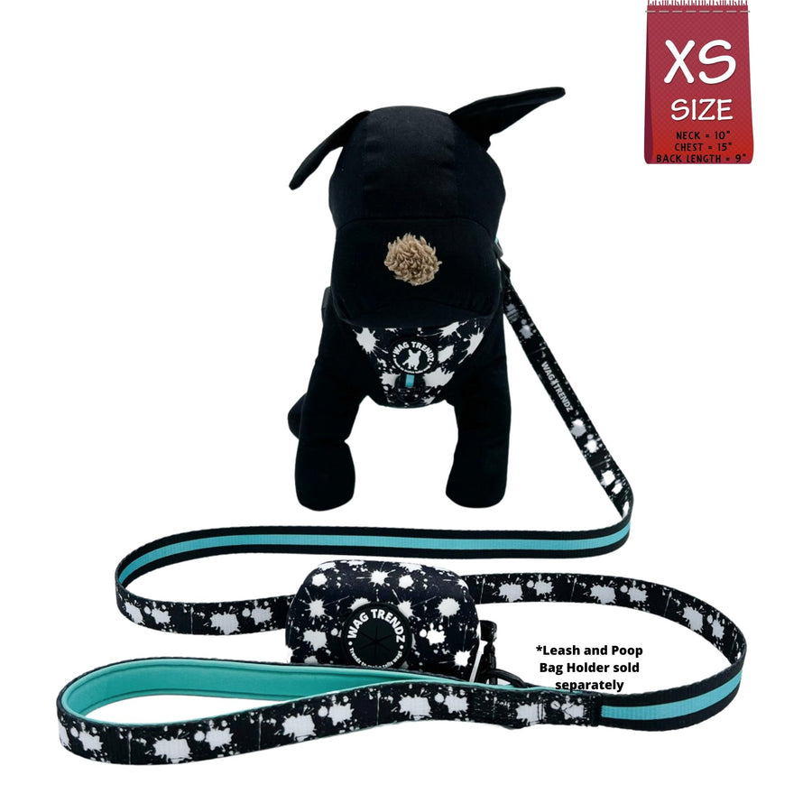 Dog Harness Vest - No Pull - black stuffed dog model wearing black adjustable harness - white paint splatter and teal accents and matching dog leash and dog poop bag holder attached- against a solid white background - Wag Trendz