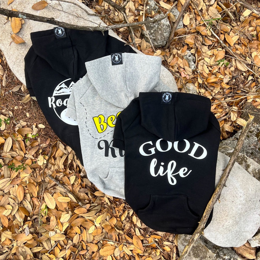 Dog Hoodie - Hoodies For Dogs - "Bee Kind" "Road Trip" & "Good Life" dog hoodies in gray and black laying on a log outdoors against a scenic fall background - Wag Trendz