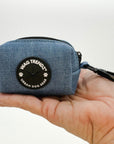 Harness and Leash Set + Poop Bag Holder - Downtown Denim Poop Bag Holder with black rubber logo - sitting in a human hand model against a solid white background - Wag Trendz