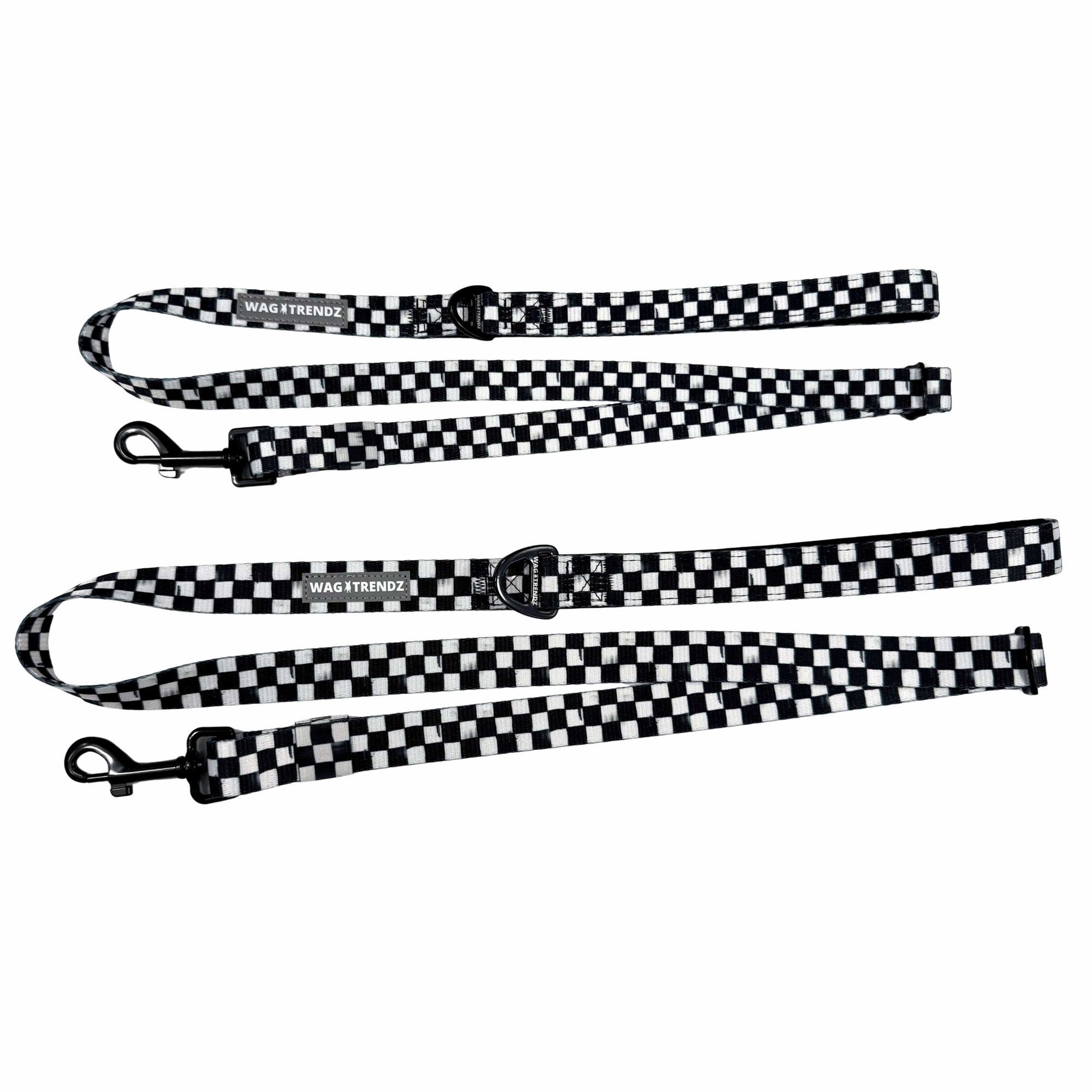 Adjustable dog leashes in messy black and white checkered with black clasps and reflective Wag Trendz® labels