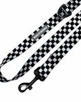 Adjustable dog leash with swivel clasp, buckle, and black and white checkered strap