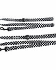 Adjustable dog leashes in messy black and white checkered with black clasps and reflective Wag Trendz® labels