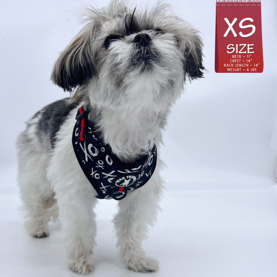Dog Harness Vests - Adjustable - Front Clip - cute black and white small dog wearing black harness with white XO's and red accents  - against a solid white background - Wag Trendz