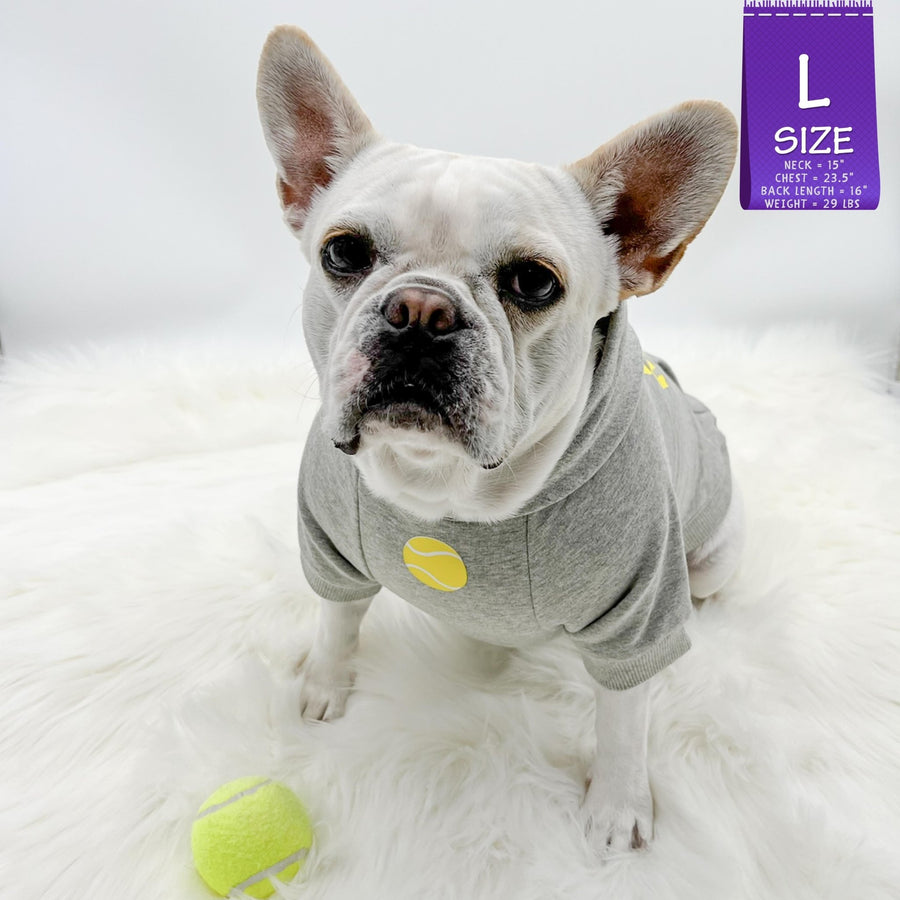 Dog Hoodie - Hoodies For Dogs - French Bulldog wearing Ball Brain dog hoodie - gray with yellow tennis ball and writing against a solid white background and a tennis ball laying on the furry white rug - Wag Trendz
