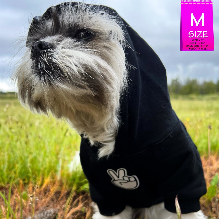 Dog Hoodie - Hoodies For Dogs - Shih Tzu mix wearing "Good Life" dog hoodie in black with hood on - front view - with white finger peace sign emoji on front - sitting outdoors in a grassy field - Wag Trendz