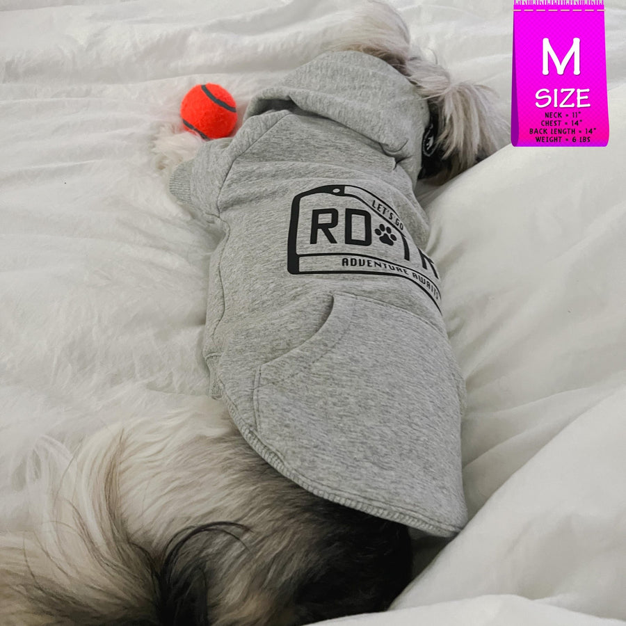 Dog Hoodie - Hoodies For Dogs - Shih Tzu mix wearing "Road Trip" License Plate design in gray - back view - laying on the bed sleeping with orange tennis ball toy - Wag Trendz